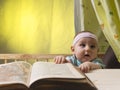 Cute little baby next to a big book Royalty Free Stock Photo