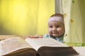 Cute little baby next to a big book Royalty Free Stock Photo