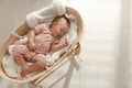 Cute little baby with pacifier sleeping in wicker crib at home, top view. Space for text Royalty Free Stock Photo