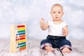 Cute little baby playing with abacus and caunting fingers Royalty Free Stock Photo