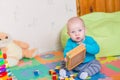 Cute little baby playing with colorful toys Royalty Free Stock Photo