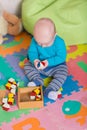 Cute little baby playing with colorful toys Royalty Free Stock Photo