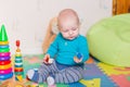 Cute little baby playing with colorful toys Royalty Free Stock Photo