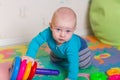 Cute little baby playing with colorful toys Royalty Free Stock Photo