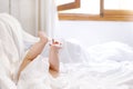 Cute little baby playing with own feet after taking bath. Adorable beautiful girl wrapped in white towels Royalty Free Stock Photo