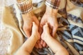 Cute little baby`s legs in mother`s hands close up in bed at home Royalty Free Stock Photo