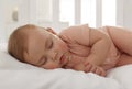 Cute little baby sleeping in soft crib, closeup Royalty Free Stock Photo