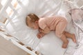 Cute little baby sleeping in soft crib at home, top view Royalty Free Stock Photo