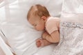 Cute little baby sleeping in soft crib, top view Royalty Free Stock Photo