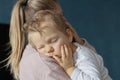 Cute little baby sleeps sweetly on mom's shoulder Royalty Free Stock Photo