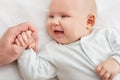 Cute little baby smiling and holding dad`s hand. love and family concept Royalty Free Stock Photo