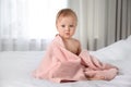 Cute little baby with soft pink towel on bed after bath Royalty Free Stock Photo