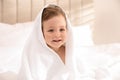 Cute little baby with soft towel on bed after bath Royalty Free Stock Photo