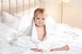 Cute little baby with soft towel on bed after bath Royalty Free Stock Photo