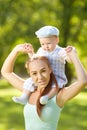 Cute little baby in summer park with mother on the grass. Swee