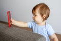 Cute little baby taking selfie holding smartphone in his hand, Royalty Free Stock Photo