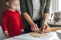 Cute little baby toddler girl making christmas cookies in home kitchen and play with dough. Mother and little girl Royalty Free Stock Photo