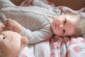 A cute little baby is woke up and lies on the bed, calm and pacified