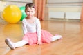 Cute little balerina stretching on floor Royalty Free Stock Photo