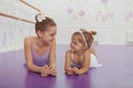 Charming two young ballerinas practicing at ballet class