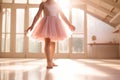 Cute little ballerina wearing pink dress dancing in white sunny studio. Girl in dance class. Child practicing ballet