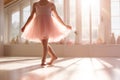 Cute little ballerina wearing pink dress dancing in white sunny studio. Girl in dance class. Child practicing ballet