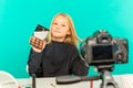 Cute little beauty blogger. Girl speaking in front of camera for vlog. Young black woman working as blogger, recording Royalty Free Stock Photo