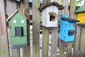 Cute little birdhouses on rustic wooden fence Royalty Free Stock Photo