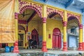 a cute little black calf tide near Brightly Painted Krishna Temple