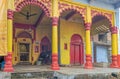 a cute little black calf tide near Brightly Painted Krishna Temple