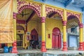 a cute little black calf tide near Brightly Painted Krishna Temple