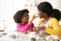 Cute Little Black Daughter And Mom Having Fun While Cooking In Kitchen Royalty Free Stock Photo