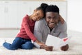 Cute little black girl greeting her dad with Fathers Day Royalty Free Stock Photo