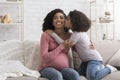 Cute Little Black Girl Kissing Her Happy Pregnant Mother At Home Royalty Free Stock Photo