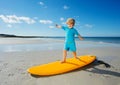 Cute little blond boy stand on the surfboard practice at beach Royalty Free Stock Photo