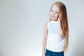 Cute little blonde European girl in casual clothes talking on the mobile phone and smiling.White Background.Copy space Royalty Free Stock Photo