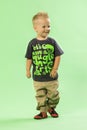 Cute little blond fashionable boy walking while smiling Royalty Free Stock Photo