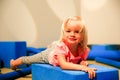 Cute Little blond girl lying on floor in playing room. Royalty Free Stock Photo