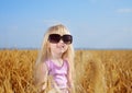 Cute little blond girl playing in a wheat field Royalty Free Stock Photo