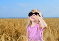 Cute little blond girl playing in a wheat field Royalty Free Stock Photo