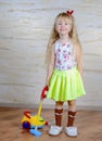 Cute little blond girl vacuuming the house Royalty Free Stock Photo