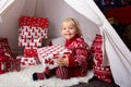 Cute little blonde boy with Christmas sweater, opening presents Royalty Free Stock Photo