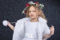 Cute little blonde girl in a beautiful white dress on a dark background Royalty Free Stock Photo