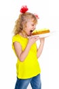 Cute little blonde girl wants to eat cake, isolated on a white background