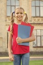Cute little bookworm. Cute smiling small child hold books educational institution background. Adorable little girl Royalty Free Stock Photo