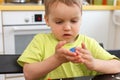 Cute little boy age of 3 years plays kinetic sand at home Royalty Free Stock Photo