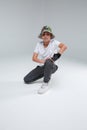 A cute little boy, break dancer, sits in a dance pose on one knee. Royalty Free Stock Photo