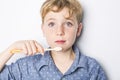 Cute little boy brushing teeth, isolated on white Royalty Free Stock Photo