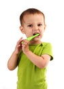 Cute little boy brushing teeth, isolated on white Royalty Free Stock Photo