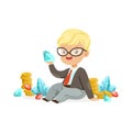 Cute little boy businessman sitting surrounded by stacks of gold coins, diamonds and rubies, kids savings and finance Royalty Free Stock Photo